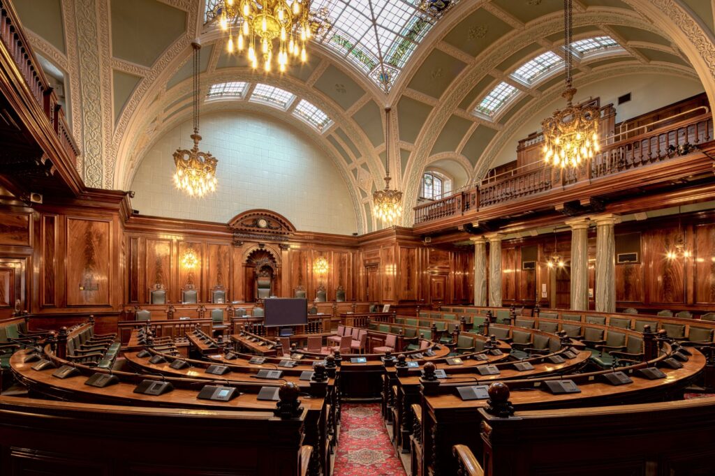 A beautifully designed chamber room with ornate woodwork and chandeliers in the UK.