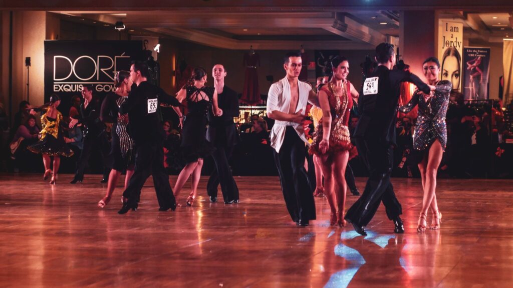 Energetic ballroom dancers performing in a vibrant stage setting. Captivating dance moves showcase elegance and style.