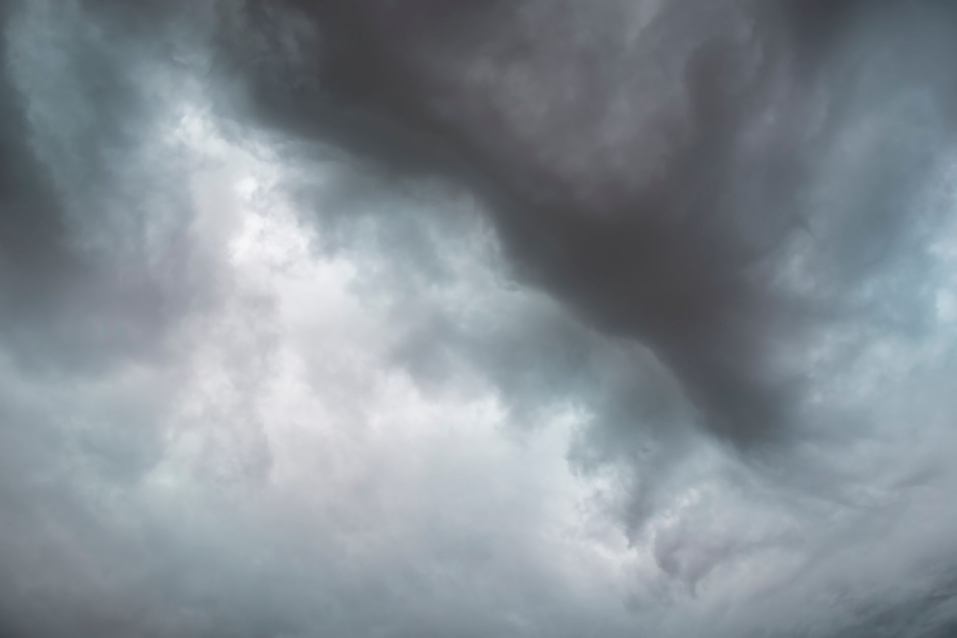 Dramatic storm clouds forming in the sky, signaling impending rain.