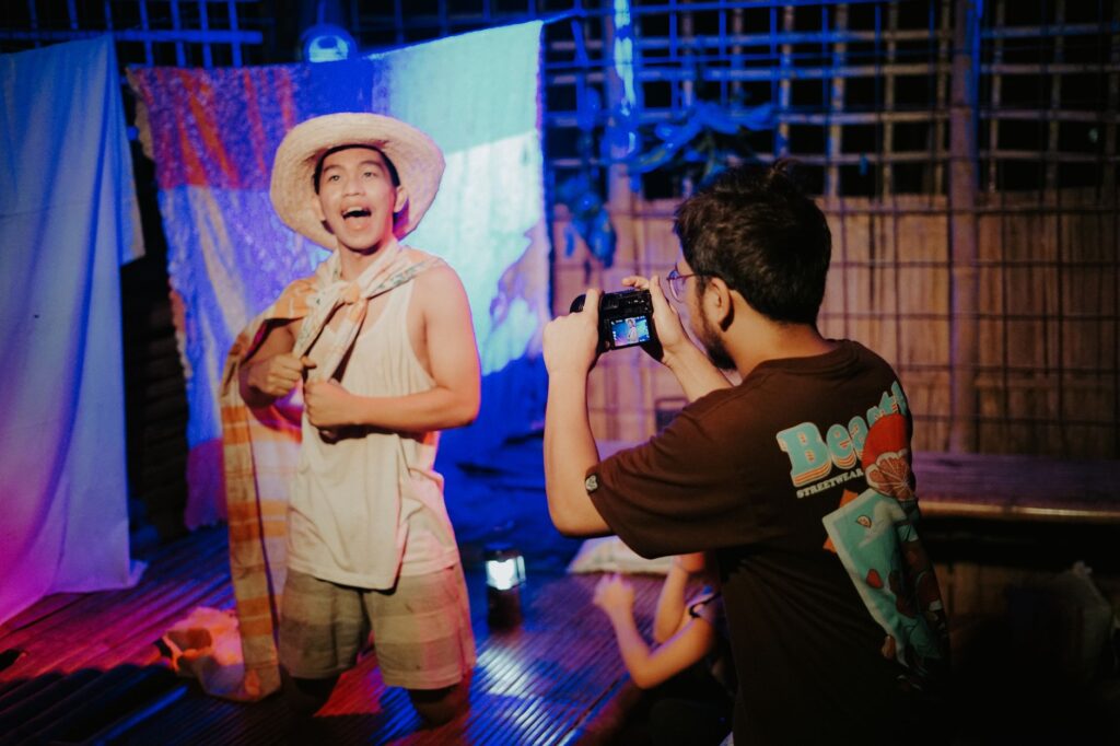 A vibrant stage performance captured with vivid lights and colorful attire, showcasing expressive artistry.