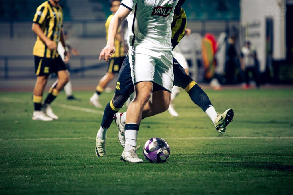 Close-up of soccer players in action during a match at an outdoor stadium.